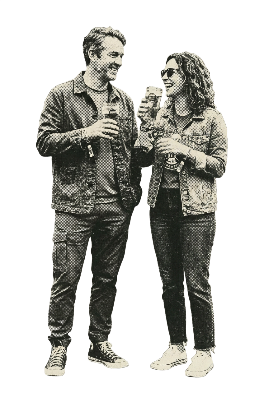 Two friends laughing over pints at a festival
